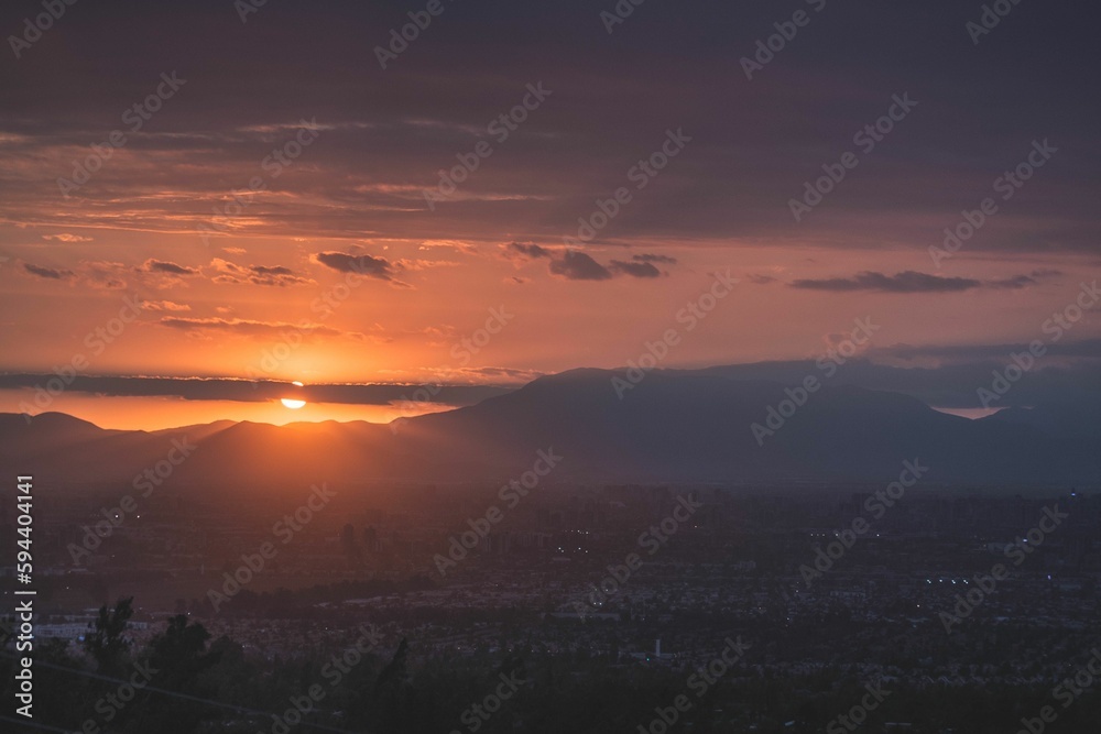 Scenic view of a country landscape at sunset with vibrant hues of orange and pink