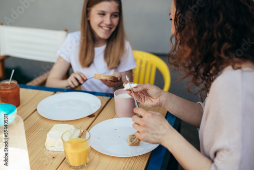 Mother and daughter enjoy having breakfast together