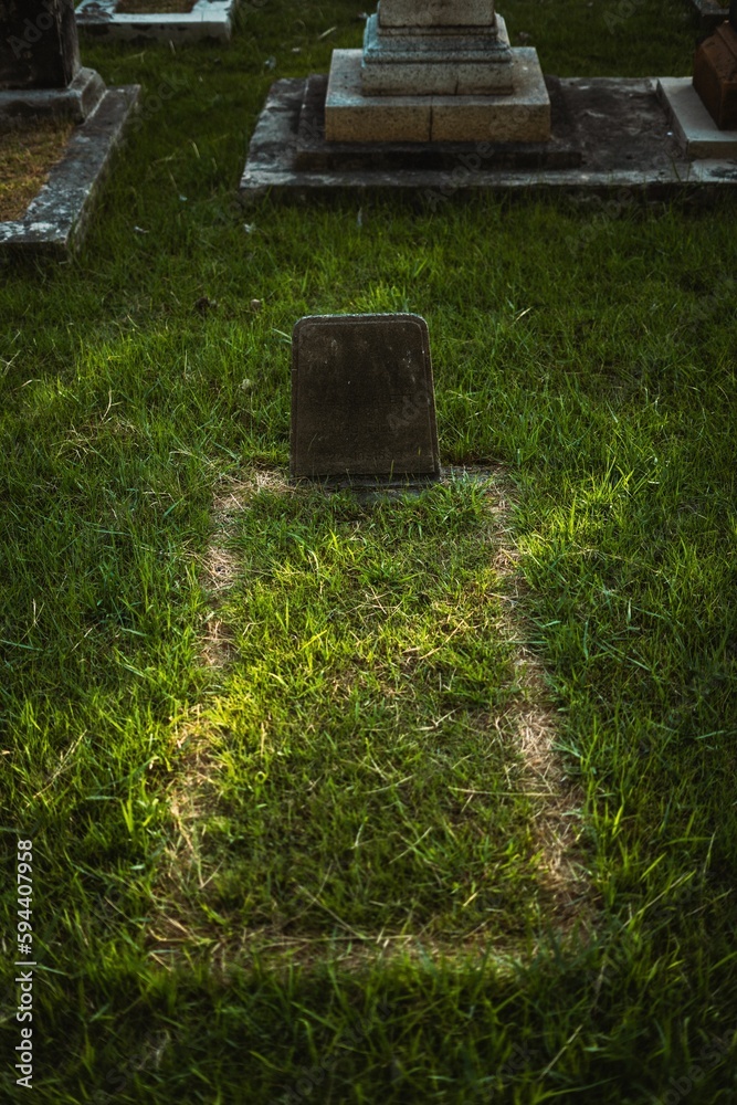 Outdoor graveyard scene featuring numerous tombstones in the background Outdoor graveyard scene featuring numerous tombstones in the background