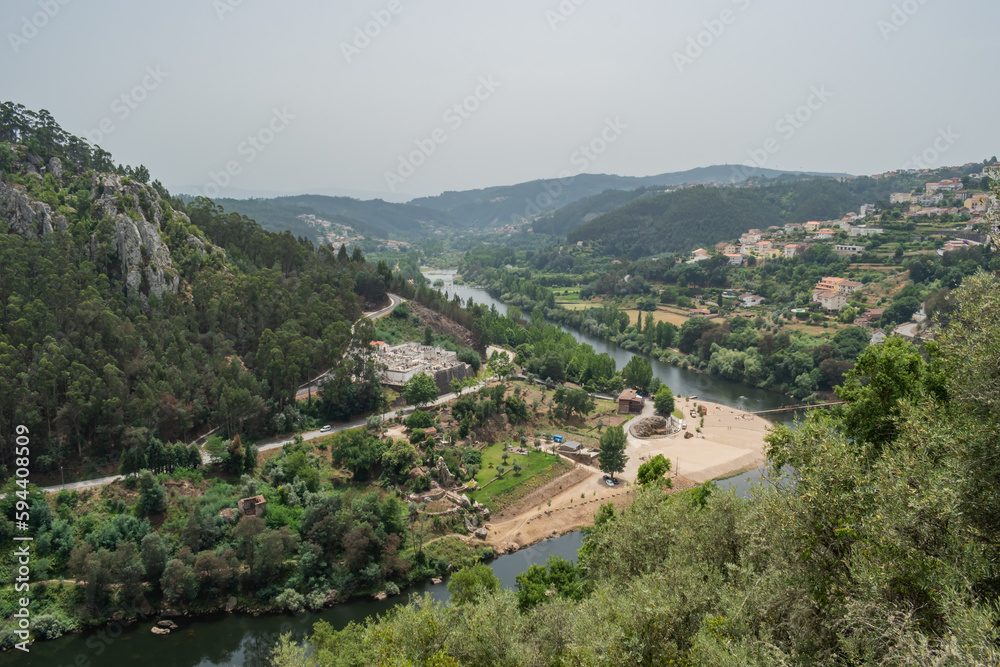 Obraz premium Treetops with leaves on the bank of the Mondego with aerial and panoramic view of the river beach of Reconquinho, Penacova PORTUGAL