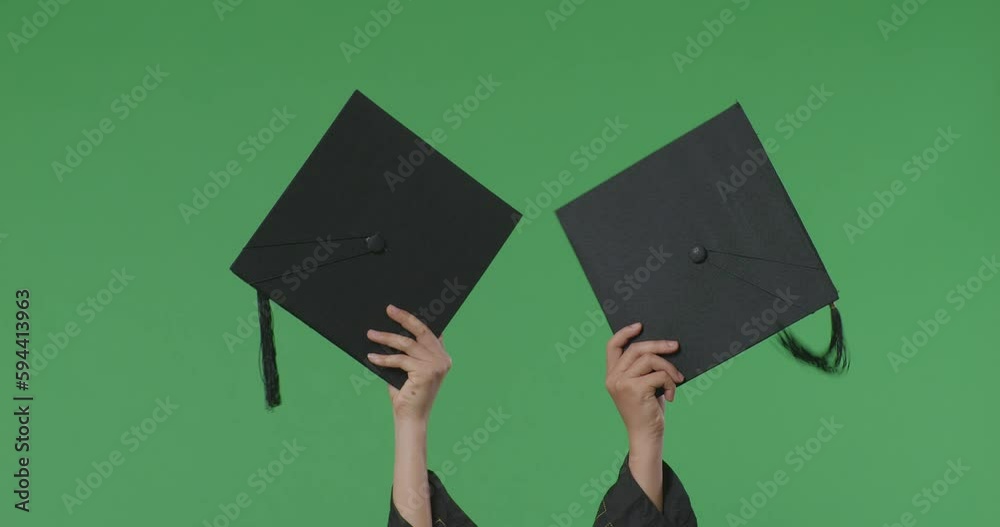 Caps Being Held Up In The Air By Woman Student'S Hands On The
