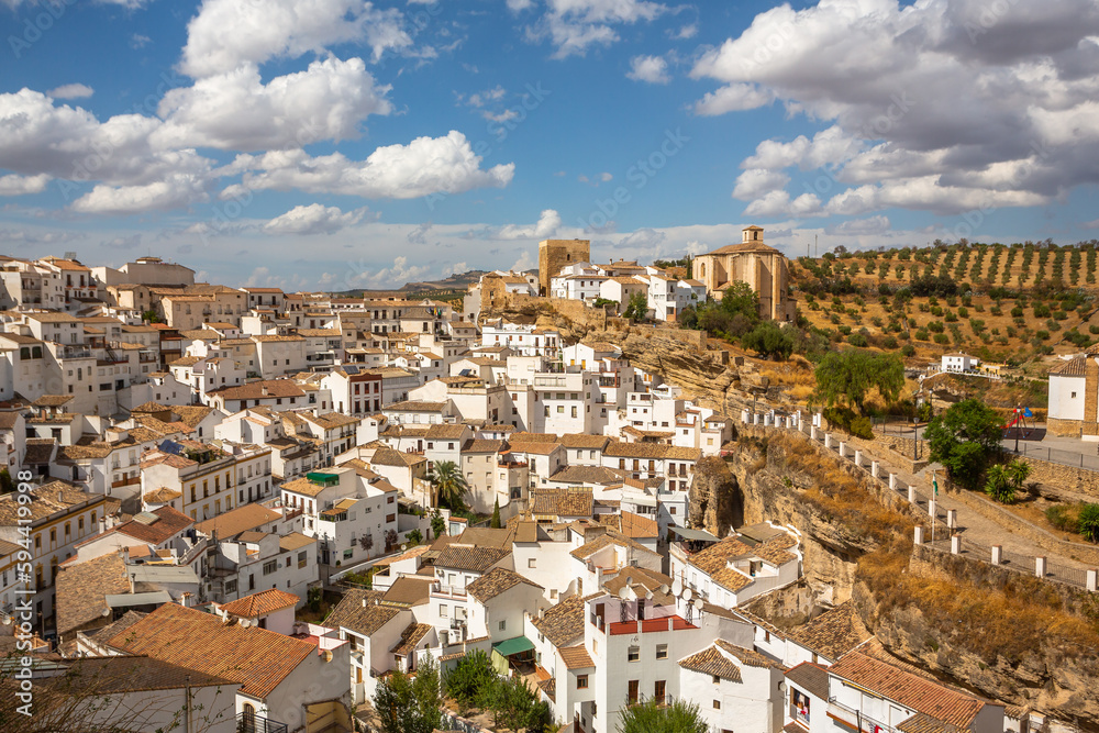 Exposure of Setenil de las Bodegas famous for its dwellings built into rock overhangs above the Rio Guadalporcun, Cadiz, Spain