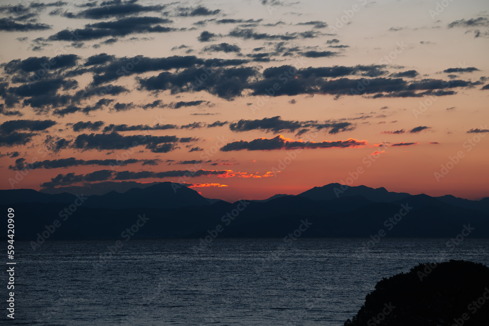 First Rays Of Sun Are Reflected In The Mountains Of Balkan Peninsula, Corfu. Concept Of sleep-wake cycle and Human Health.
