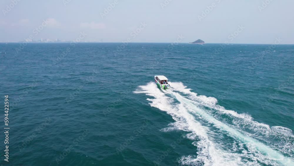 Speedboat with passenger sailing to tropical island on blue sea Speedboat with passenger sailing to tropical island on blue sea