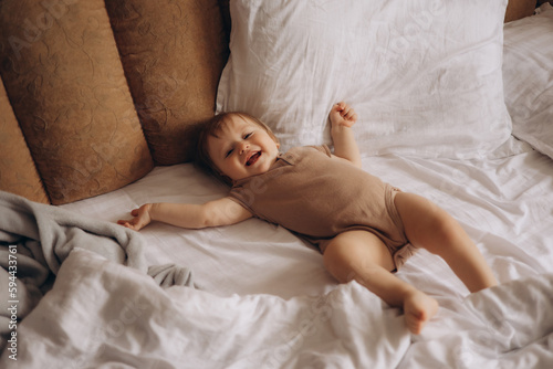 A baby is lying on a bed with a pillow