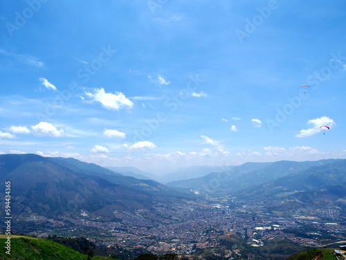 Medellin, Colombia - 20.05.2015: Paragliders flying above Medellin