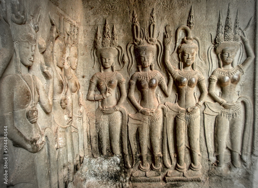 Siem reap, Cambodia - August 5th 2010 : Site of the Angkor temples. Angkor Vat Temple. Focus on a bas-relief representing Apsaras (celestial nymphs) on a pillar.