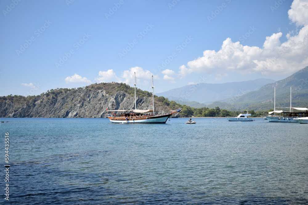 Pleasure ship in the bay at sea. Ship. mountains, forest, beaches. Türkiye, Phaselis