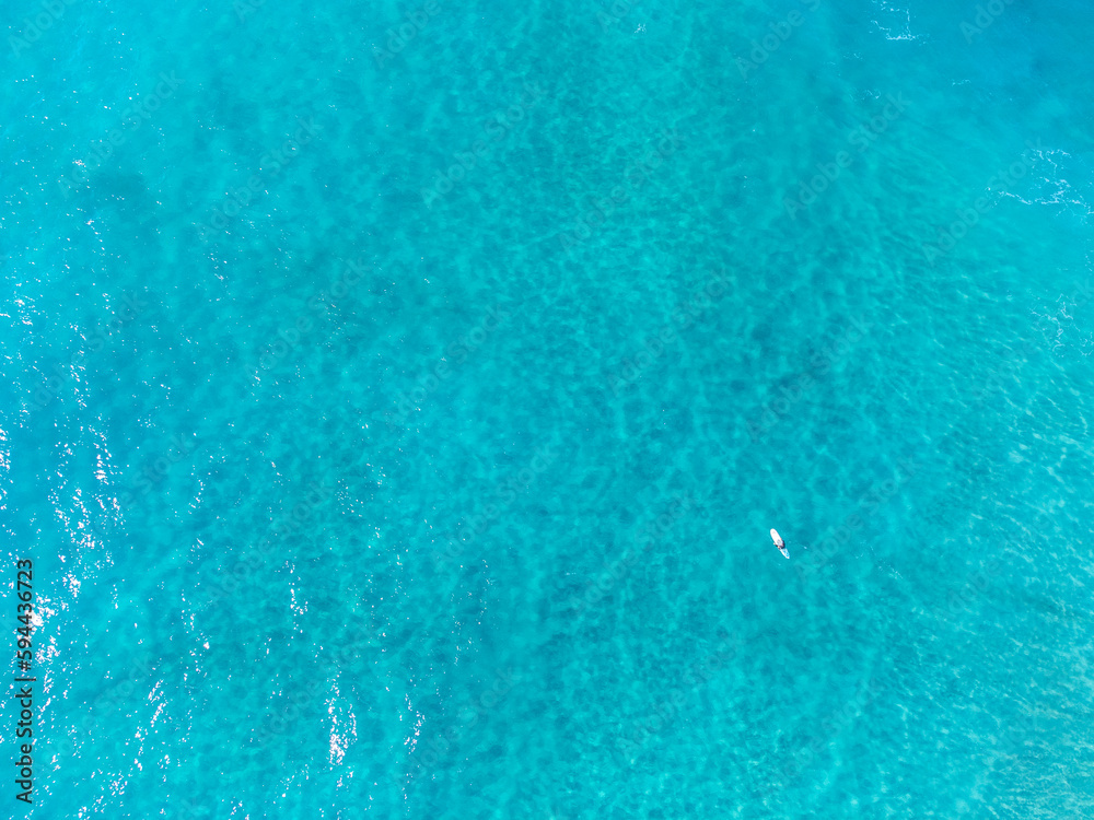 Aerial view of surfer surrounded by water Aerial view of surfer surrounded by water