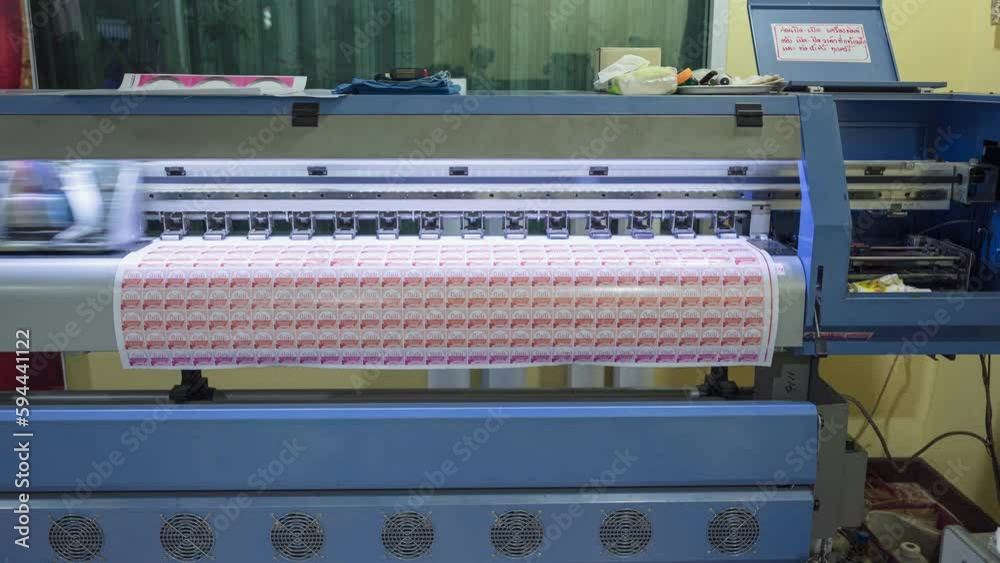 Large format inkjet printer printing on sticker sheet with branding and ...