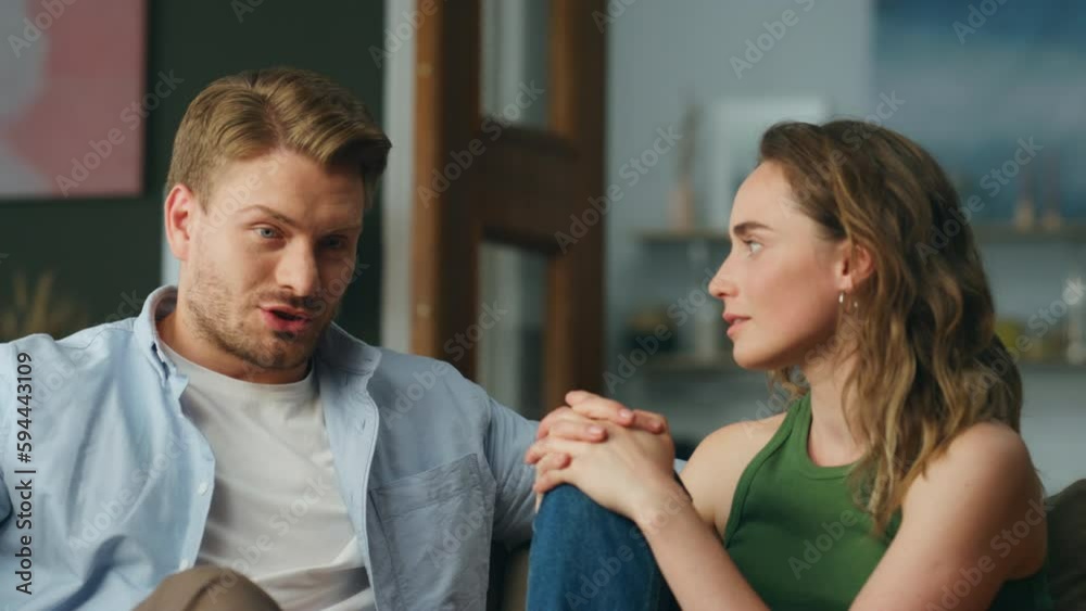 Emotional man telling story to wife home closeup. Serious lovers talking sofa Emotional man telling story to wife home closeup. Serious lovers talking sofa