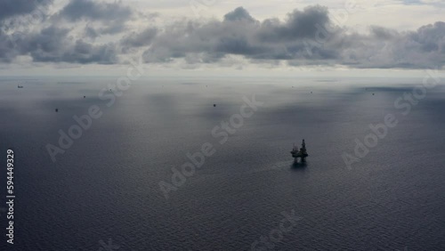 Jack up drilling rig and production platform in the middle of the ocean during couldy time
 photo
