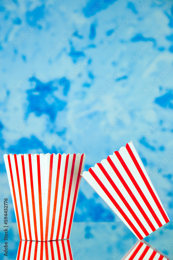 Obraz premium front view popcorn packages on a light blue background food snack friends cips corn color company