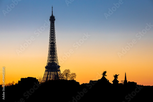 Paris, France - February 8, 2023: Skyline of Paris at sunset with Eiffel Tower silhouette © JEROME LABOUYRIE