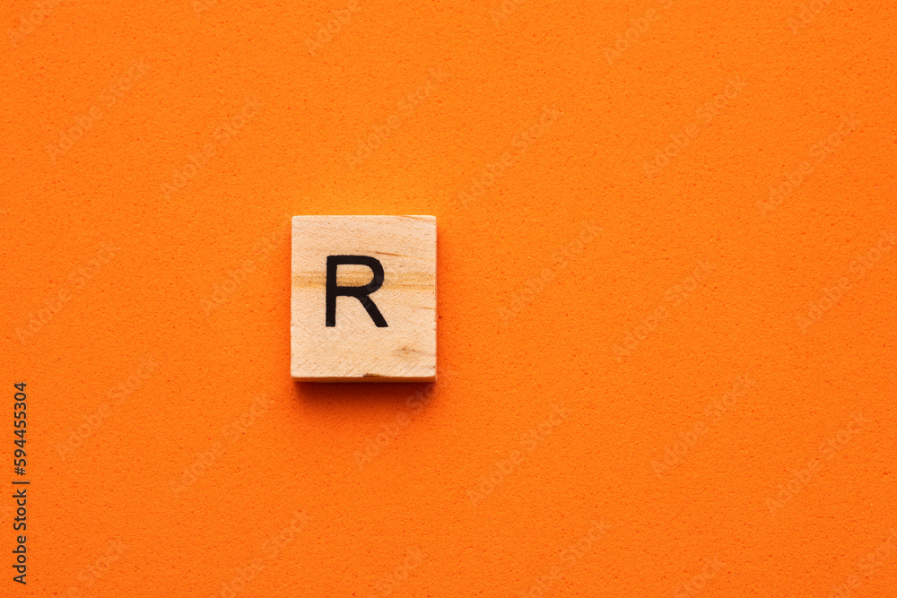 Alphabet letter R on wooden square tile - Orange foamy background Alphabet letter R on wooden square tile - Orange foamy background