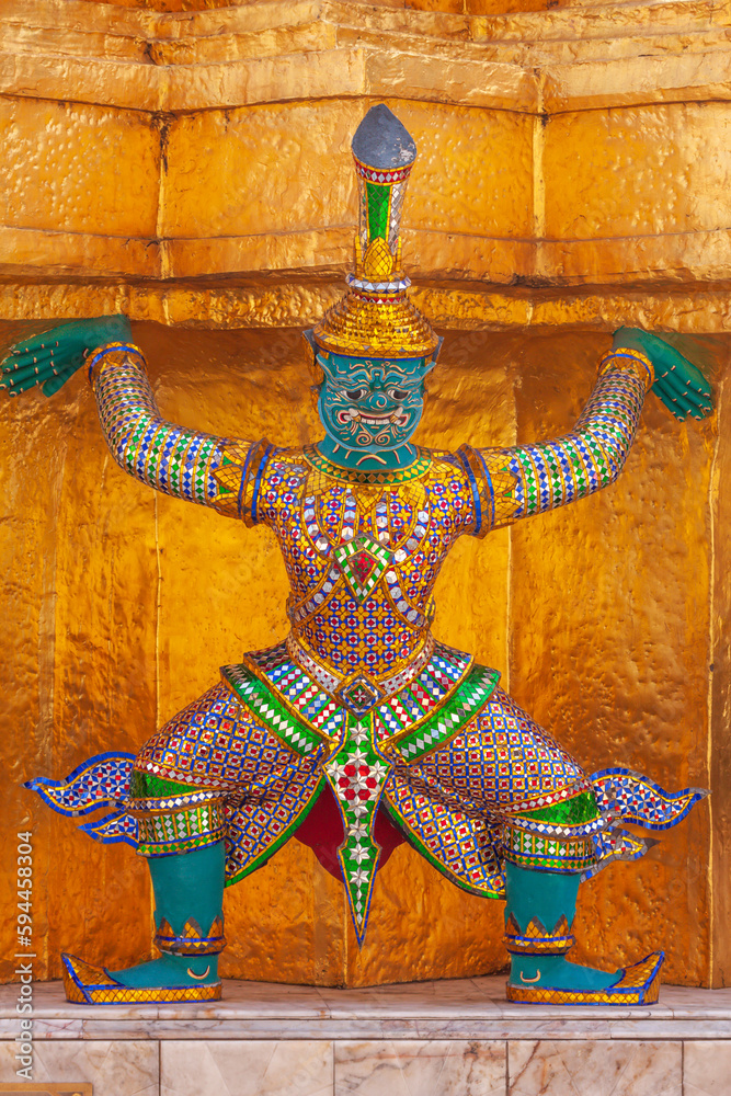 Thailand, Bangkok. Yaksha, demon depicted in the Ramayana, guarding Wat Phra Kaew (Temple of The Emerald Buddha).