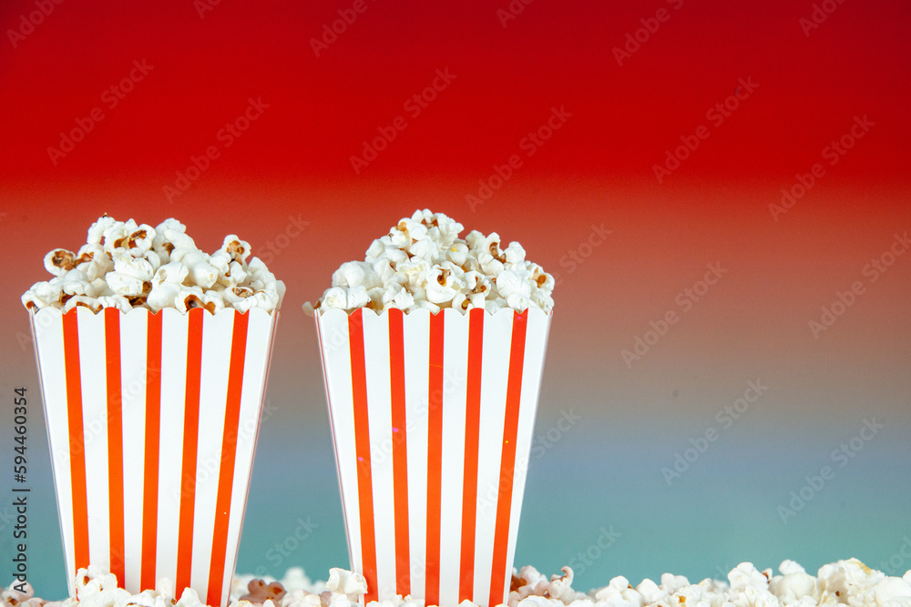 front view fresh popcorn in white and red striped packages on light red background snack cinema cips color photo corn movie free space