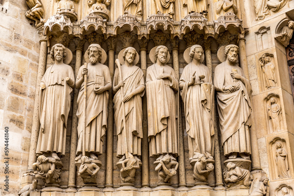 France, Paris. Front facade of Notre Dame. Statues of saints.