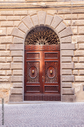 Italy, Umbria, Orvieto. Traditional ornate door in the town of Orvieto.