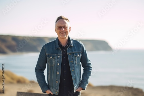 Portrait of a handsome middle-aged man standing on the beach