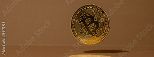 Bitcoin gold coin levitation with shadow reflection. Bitcoin flying mining trading concept. BTC golden money. Worldwide virtual internet Cryptocurrency or crypto digital payment system. Digital coin photo