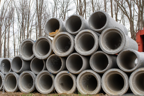 large concrete sewer pipes up on the ground
