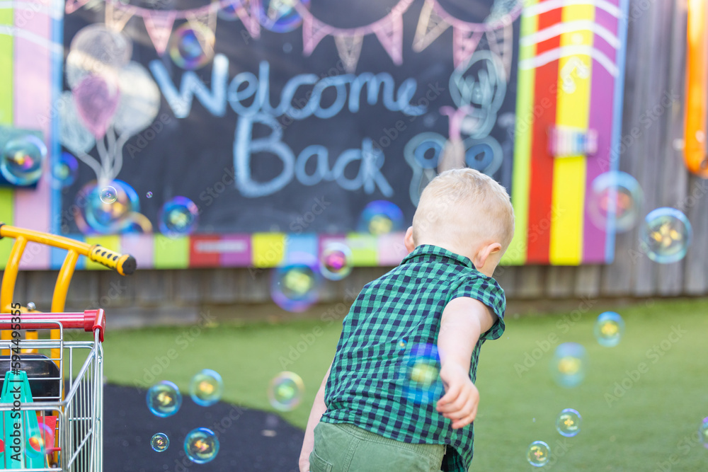 Fototapeta premium Preschool child playing in a vibrant fun outdoor kindergarten yard