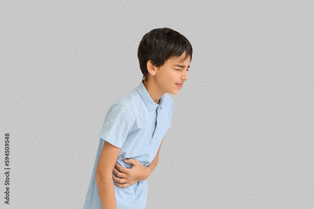 Little boy with appendicitis on grey background Little boy with appendicitis on grey background