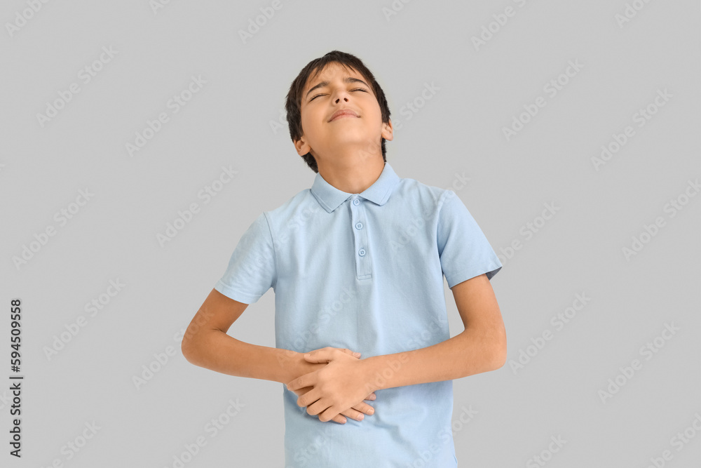 Little boy with appendicitis on grey background Little boy with appendicitis on grey background