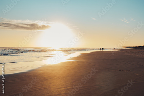 Long exposure of bright orange sunset over the tropical sea and sky with clouds. Beautiful sunset blue summer.