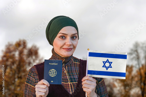 Muslim Woman Holding Passport and Flag of Israel  © mirsad