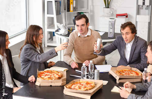 Group of business people with tasty pizza in office