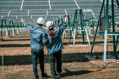 Solar design engineers visually inspect photovoltaic array installation sites for suitable alignment, surface, sunlight access, and structural stability. System maintenance and operation records. © SpaceOak