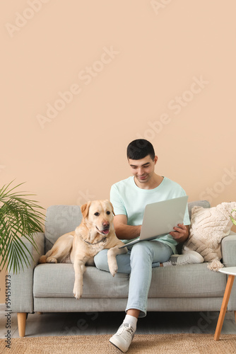 Young man with laptop and h...