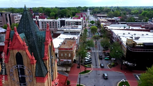 Big Building with clock tower and red roof. Anderson County Human Resources. City hall. Aerial shot above. 