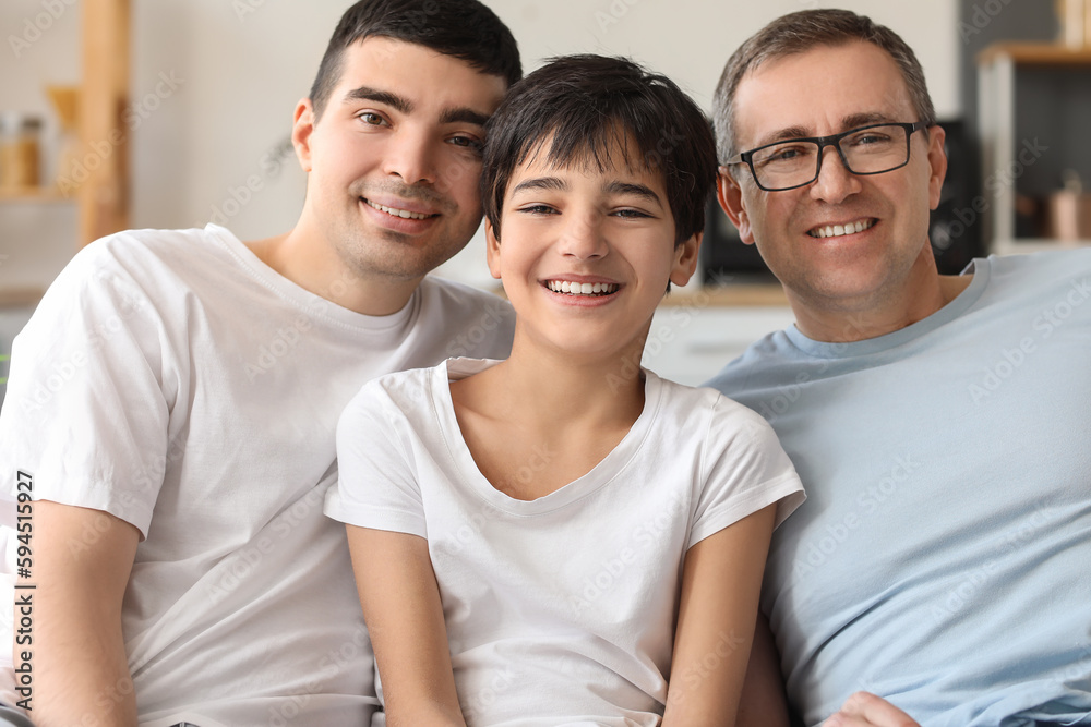 Happy little boy with his dad and grandfather at home Happy little boy with his dad and grandfather at home