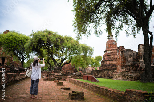 Summer Travel archaeological site in Asia. Asian woman traveler temple in Ayutthaya Historical Ancient temple archeology historic site.