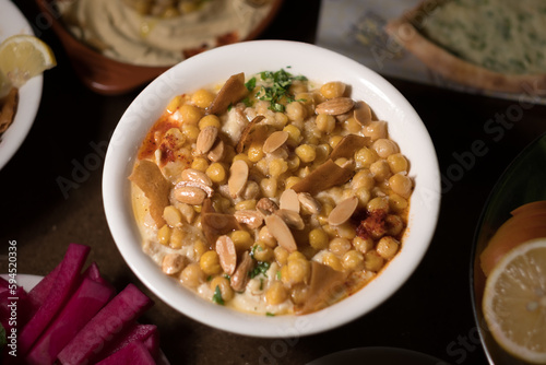 Chickpeas and yogurt are cooked together to make a tasty dish, topped with fried pita bread and sliced almonds.