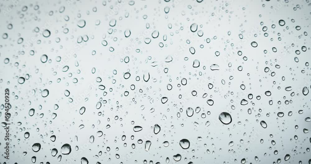 Rain water drops on window transparent glass abstract background. Natural bad weather gray colors. Rain water drops on window transparent glass abstract background. Natural bad weather gray colors.