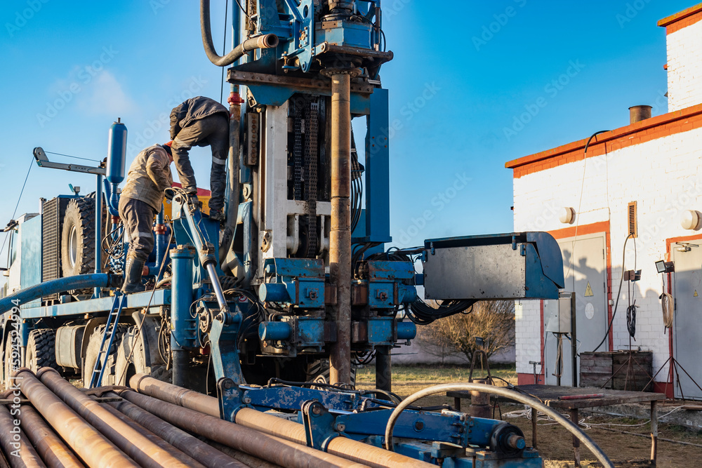 Naklejka premium Drilling rig repair and maintenance. Preparation for drilling operations. Drilling of deep wells. Exploration work. Mineral exploration. Extraction of gas and oil.