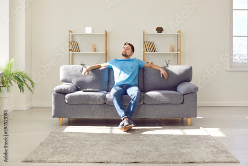 Tableau sur toile Young man relaxing on couch