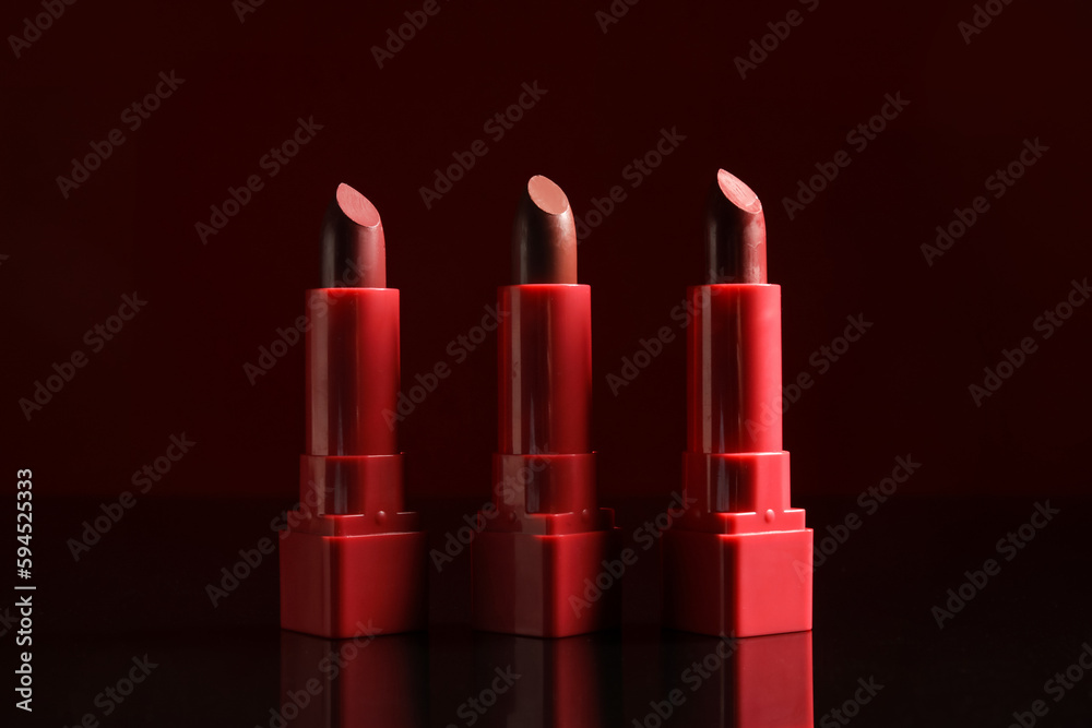 Set of beautiful lipsticks on dark background Set of beautiful lipsticks on dark background