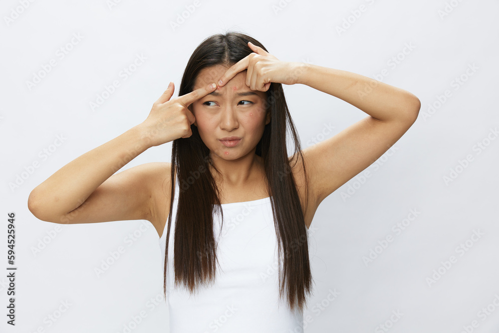 Asian woman facial skin problems, acne and inflammation, red rashes and allergies, chicken pox, sadness from rashes. Facial skin care concept for diseases and nerves Asian woman facial skin problems, acne and inflammation, red rashes and allergies, chicken pox, sadness from rashes. Facial skin care concept for diseases and nerves