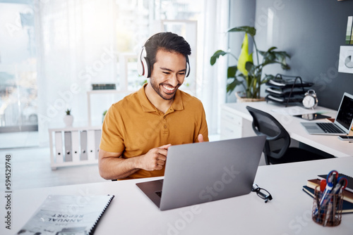 Business man, laptop and headphones to listen to music, audio or webinar. Asian male entrepreneur at desk listening to a song or video call while online on social media with internet connection