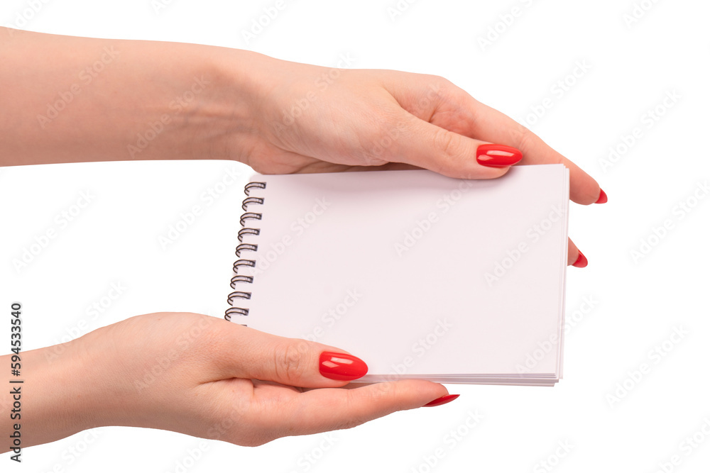 A notebook with empty white paper in woman hands with red nails. A notebook with empty white paper in woman hands with red nails.