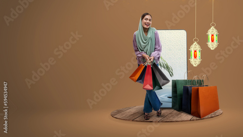Asian Muslim woman in a headscarf holding shopping bags