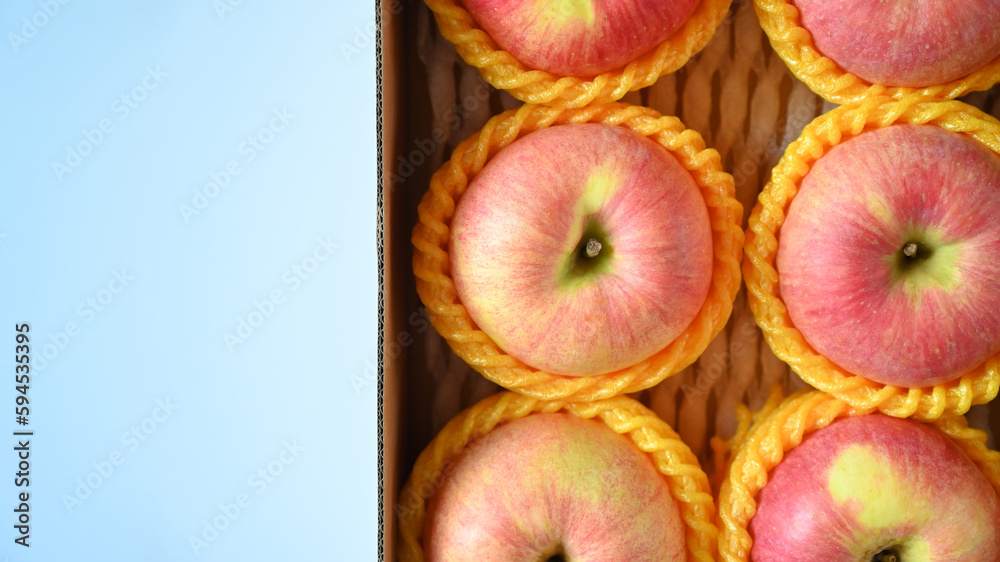 beautiful pink apple in the box on blue background beautiful pink apple in the box on blue background