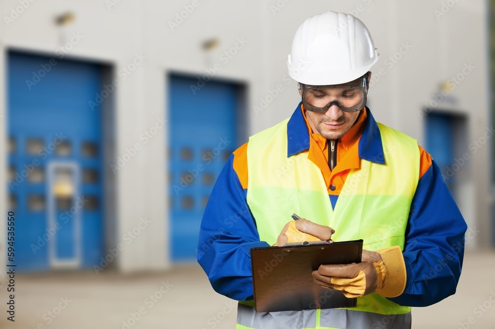 Portrait of smart engineer wearing safety helmet use clipboard Portrait of smart engineer wearing safety helmet use clipboard