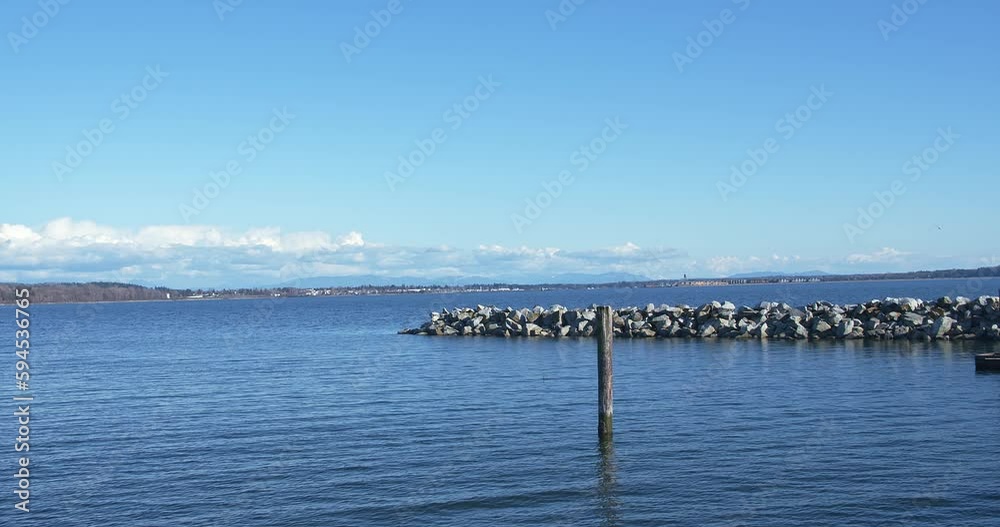 Seascape in sunny day, White Rock, BC, Canada. Shore, rocks, blue sky seen in footage Seascape in sunny day, White Rock, BC, Canada. Shore, rocks, blue sky seen in footage