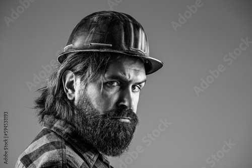 Bearded man worker with beard in building helmet or hard hat. Man builders, industry. Building, industry - builder concept. Black and white